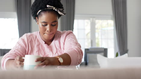 African-American-woman-enjoys-a-cup-of-coffee-at-home