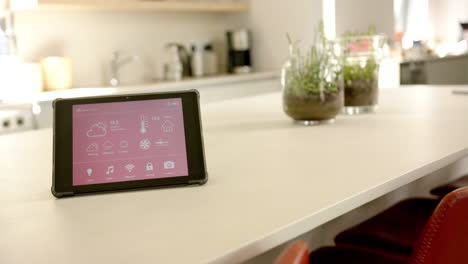 A-smart-home-interface-sits-on-a-kitchen-counter,-copy-space