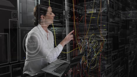 Animation-of-data-processing-over-caucasian-female-it-technician-with-laptop-over-computer-servers