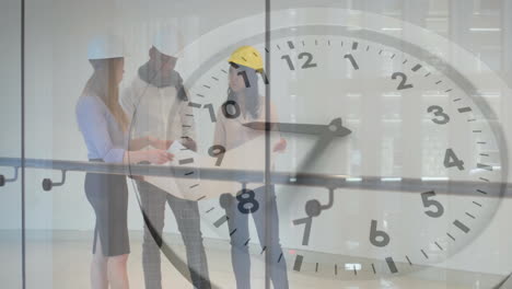 Animation-of-clock-moving-over-diverse-colleagues-discussing-work
