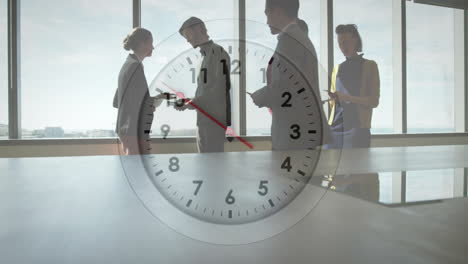 Animation-of-clock-moving-over-diverse-colleagues-discussing-work