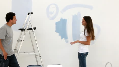 Woman-drawing-a-heart-on-the-wall-