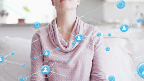 Animation-of-network-of-connections-with-icons-over-caucasian-woman-meditating