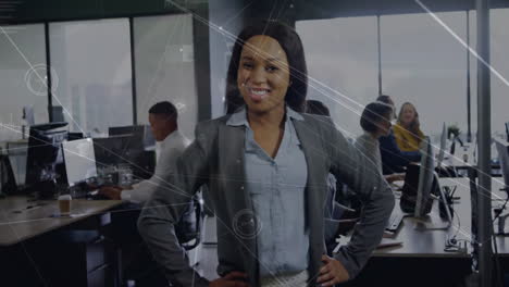Animation-of-network-and-data-processing-over-happy-african-american-businesswoman-at-office