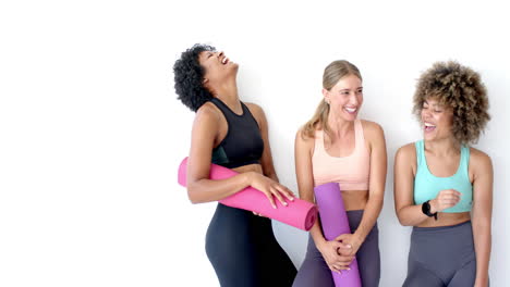 Three-women-laughing-against-white-background