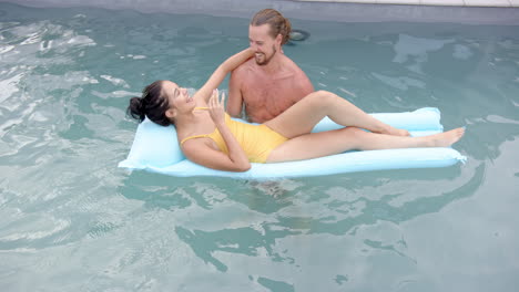 A-young-biracial-couple-enjoys-a-relaxing-moment-in-a-pool