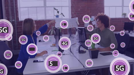 Animation-of-network-of-5g-text-and-icons-over-diverse-business-people-in-office