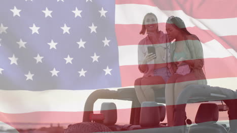 Animation-of-flag-of-usa-over-happy-diverse-women-on-car-by-beach-in-summer