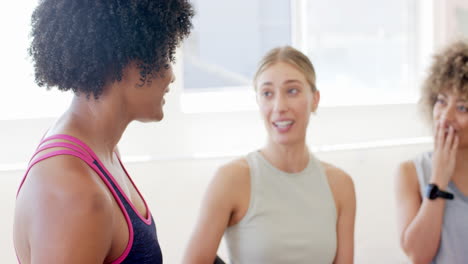 Three-women-are-chatting-in-bright-room,-two-biracial-and-one-Caucasian