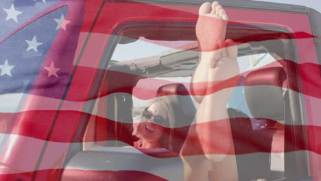 Animación-De-La-Bandera-De-Estados-Unidos-Sobre-Una-Mujer-Caucásica-En-Un-Auto-En-La-Playa.