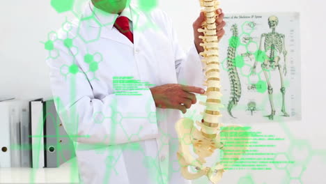 Animation-of-medical-data-processing-over-midsection-of-caucasian-male-doctor-explaining-spine