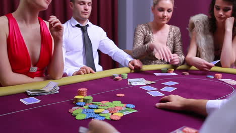 Woman-going-all-in-and-other-people-at-table-folding