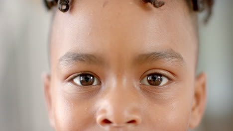 Close-up-of-a-young-African-American-boy-with-brown-eyes-at-home