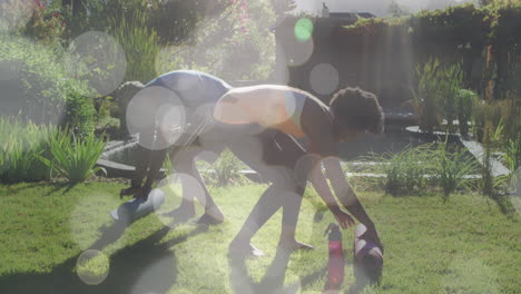 Animation-of-light-spots-over-african-american-couple-rolling-yoga-mats,-slow-motion