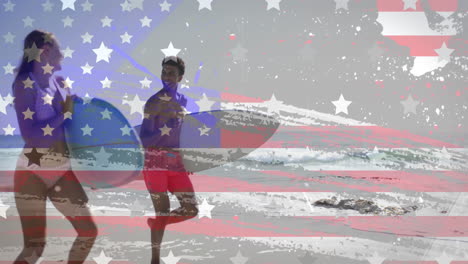 Animation-of-american-flag-over-happy-diverse-couple-with-surfboards-running-on-sunny-beach