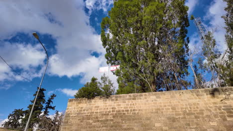 Ein-Abschnitt-Der-Alten-Stadtmauer-In-Nikosia,-Zypern,-Mit-Einem-Hohen-Baum-Und-Einem-Fahnenmast-Sichtbar