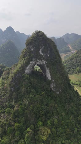 Nguom-Ngao-Cave,-Cao-Bang---Scenic-Limestone-Mountain-in-aerial-view,-vertical