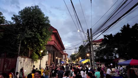 Philippines,-Manila:-The-video-captures-an-aerial-view-of-a-crowd-heading-to-the-plaza-of-Manila-Cathedral-in-Intramuros-for-the-Easter-Holy-Week-ceremony