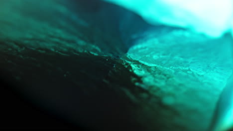Abstract-close-up-of-turquoise-ink-diffusing-through-water,-creating-vivid,-organic-patterns