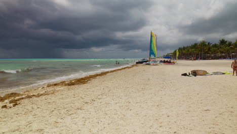 Cloudy-day-at-Playa-Del-Carmen-Mexico-with-a-calm-beach-and-palm-trees
