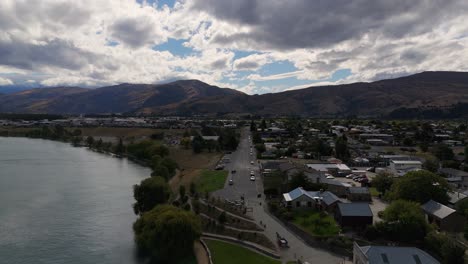 Drone-flies-backward-captures-old-part-of-town-Cromwell,-New-Zealand---Cloudy-weather