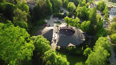 Imágenes-Aéreas-Del-Concierto-De-Música-En-Vivo,-Escenario-Del-Parque-Al-Aire-Libre,-Multitud,-Puesta-De-Sol-4k