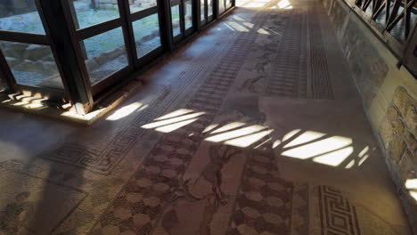 Ground-level-view-of-an-ancient-mosaic-floor-inside-a-historical-building-in-Pafos,-Cyprus