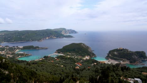 Greece,-Corfu:-The-video-captures-an-aerial-view-of-Corfu-Island's-coastline,-highlighting-its-indentations,-beaches,-and-turquoise-blue-water