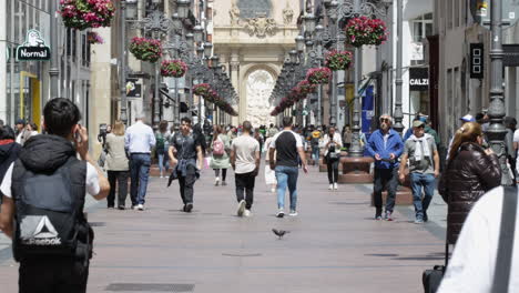 People-walking-on-the-Pedestrian-Street-Of-Calle-Alfonso-In-The-City-Center-Of-Zaragoza,-Aragon-Spain