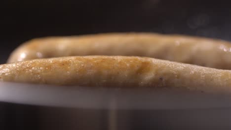 Closeup-shot-of-sauage-cooking-in-pan