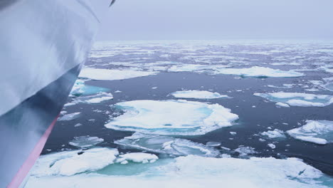 Bow-of-Boat-Sailing-Between-Broken-Pieces-of-Ice-in-Artic-Circle-and-North-Pole,-Slow-Motion