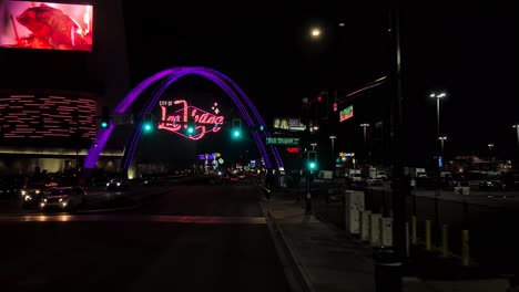 Las-Vegas-USA,-Driving-on-Strip-at-Night,-Front-View-of-Neon-Landmark-SIgn-and-Start-Hotel-Casino