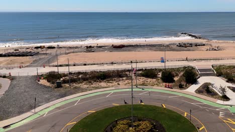 An-aerial-view-over-a-traffic-circle-in-Queens,-New-York-on-a-sunny-day-with-blue-skies