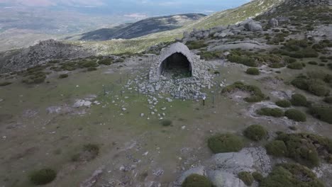 flight-with-a-drone-in-the-privileged-location-of-the-hermitage-of-San-Pedro-14th-century-we-visualize-it-with-a-perimeter-fence,-their-bodies-are-vaulted-and-many-remains-on-the-ground-Avila-spain