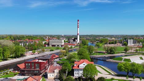 Klaipeda,-lithuania-with-a-central-heating-chimney-and-lush-green-surroundings,-aerial-view