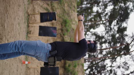 Vertical-view-of-male-aim-handgun-and-remove-magazine-with-bullets,-Czechia