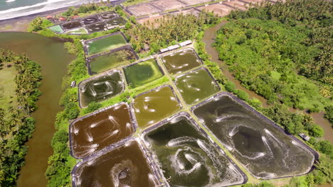 Inland-shrimp-farming-ponds-in-Bali-being-aerated-at-surface,-aerial-view