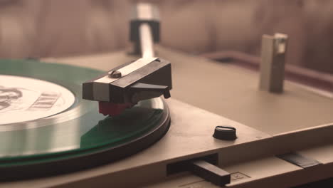 Green-Vinyl-Record-on-Spinning-Gramophone-Turntable-and-Cigar-Smoke,-Home-Ambience-in-1970's,-Close-Up