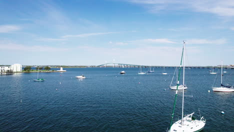 Drone-flight-over-Narragansett-Bay,-the-Claiborne-Pell-Bridge-in-the-distance