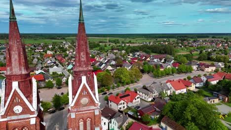 The-historic-church-in-s-veks-na,-lithuania-on-a-sunny-day,-aerial-view