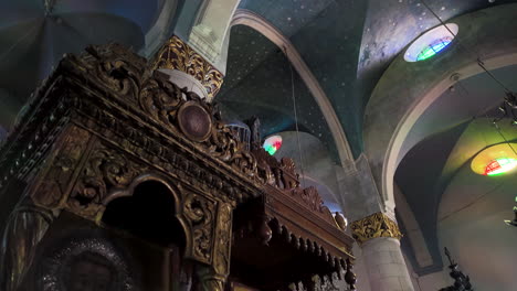 The-ceiling-of-an-Orthodox-church-in-Lefkara,-featuring-a-painted-dome-with-religious-frescoes-and-a-grand-chandelier