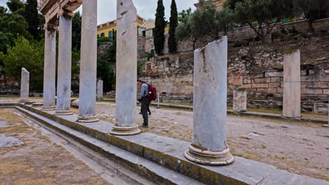 East-Propylon-colonnade,-tourist-meander-at-gray-Hymettian-ionic-columns---slow-motion-shot