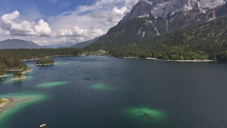 Walensee-Lake-in-Switzerland,-is-surrounded-by-dense-forests-and-towering-mountains-under-a-partly-cloudy-sky