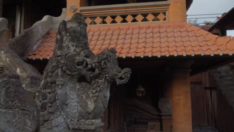 Detailed-footage-of-a-traditional-Balinese-stone-dragon-statue-in-front-of-a-historic-temple