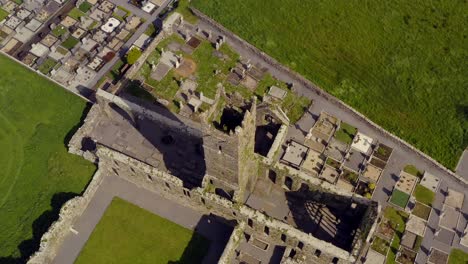 Claregalway-Abbey-establishing-shot,-rising-up,-rotating-and-giving-a-unique-perspective