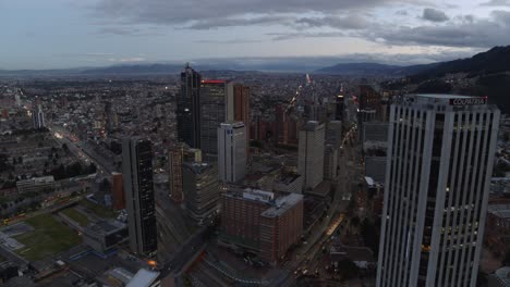 Drone-shot-of-downtown-Bogota,-Colombia-at-sunrise-on-a-cloudy-day