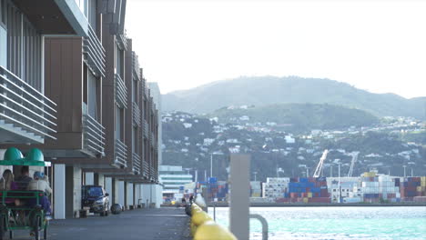 A-quadracycle-cycles-down-the-waterfront-in-Wellington,-New-Zealand