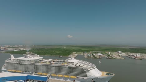 An-aerial-drone-provides-a-flyover-view-of-the-Royal-Caribbean-Harmony-of-the-Seas-cruise-ship-docked-at-the-Royal-Caribbean-Terminal-in-Galveston,-Texas