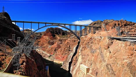 Hoover-Dam-Road-Bridge-Between-Canyon-on-a-Sunny-Day-with-Blue-Skies,-Wide-Shot,-Nevada,-USA