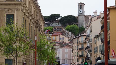 Cannes-sign-on-hill-by-buildings-in-Old-Town,-establishing-shot